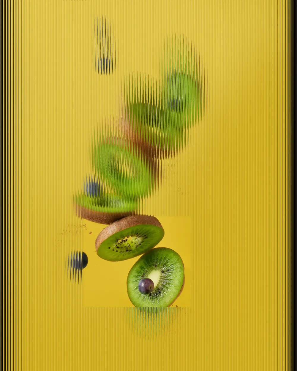 Kiwi slices and blueberries on a yellow background seen through vertical fluted glass, with one clear rectangular window where two kiwi slices stay sharp.